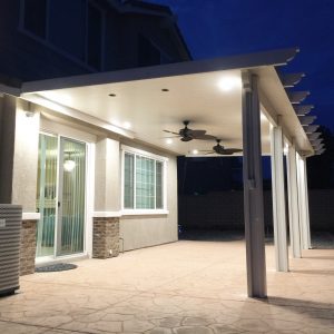 Custom white patio cover with lighting and ceiling fans