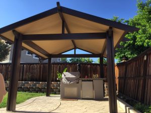 Custom gazebo area in a paved backyard