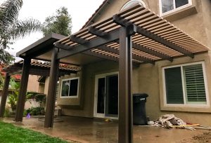 Custom patio cover being installed in rainy weather