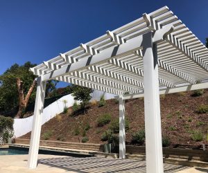 White Pergola next to a pool