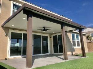 Small patio cover attached to a two-story house