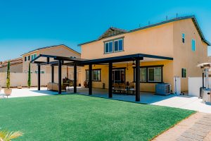 Large dark aluminum patio cover installed by Superior Patios
